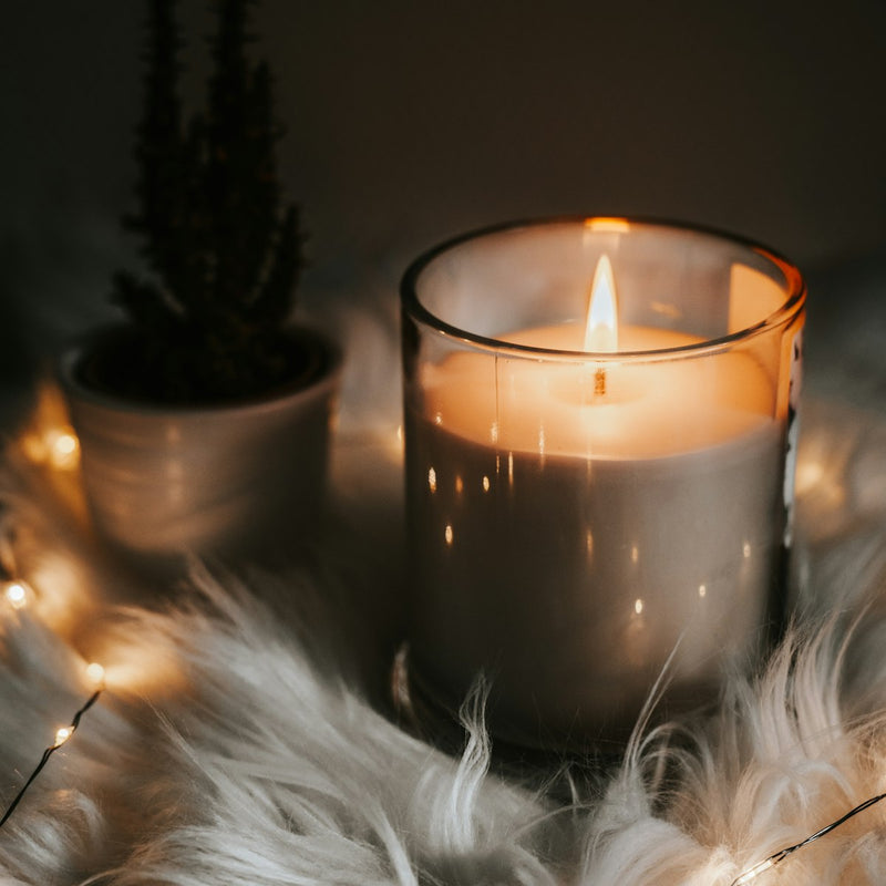 Hand-poured scented soy candle in amber glass jar